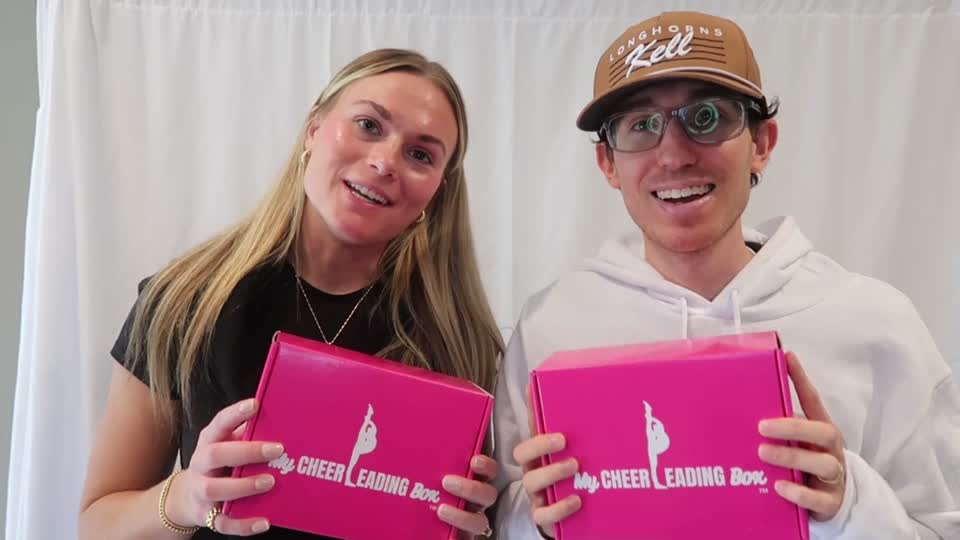 The MyCheerleadingBox team holding two pink boxes